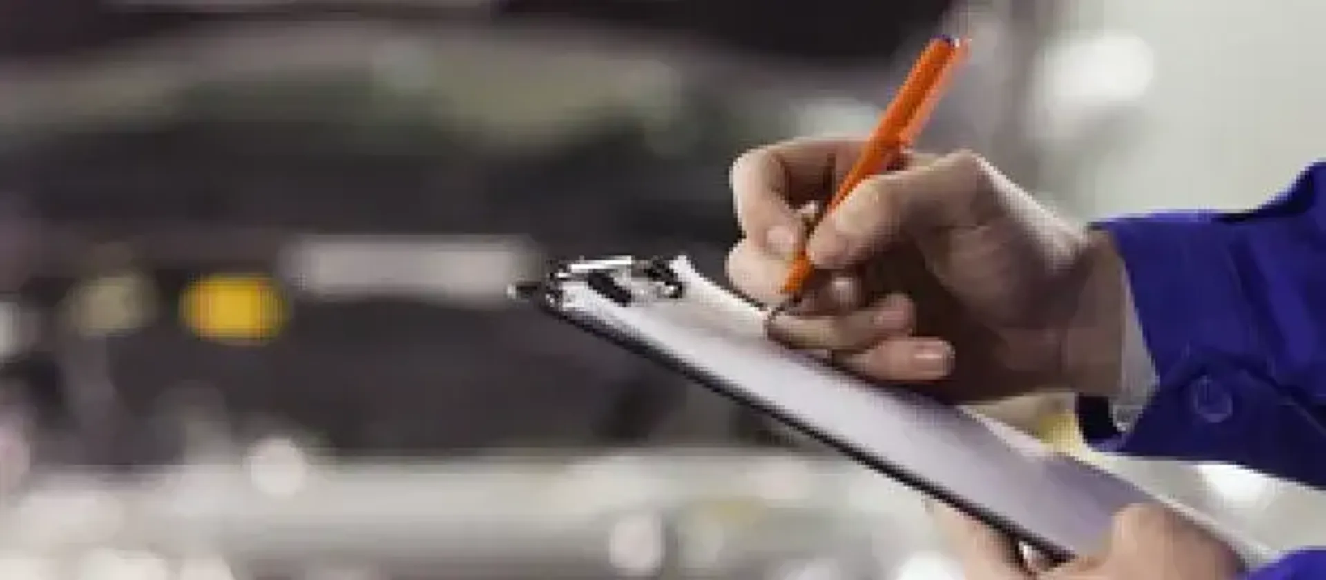 Man ticking off on a clipboard